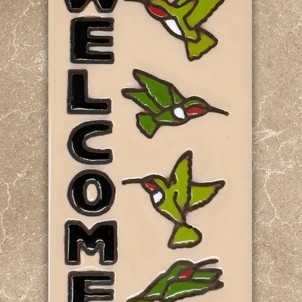 welcome hummingbirds tile on beige background
