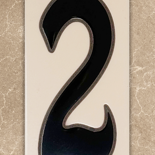 Black number '2' on a beige background