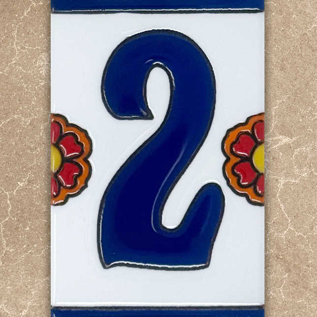 Decorative tile with the number '2' in blue, surrounded by floral designs on a beige background