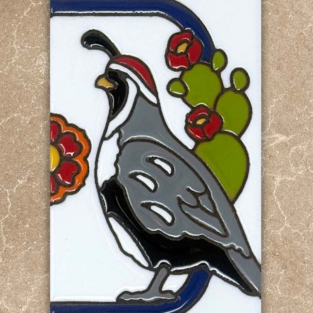 Decorative tile with a quail and cactus design on a beige background