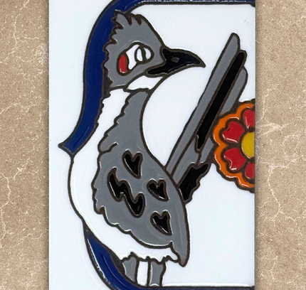 roadrunner talavera end cap house number tile on beige background