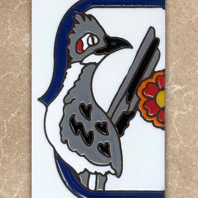 roadrunner talavera end cap house number tile on beige background