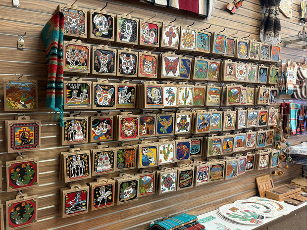 Wall display of small framed artworks in a store setting