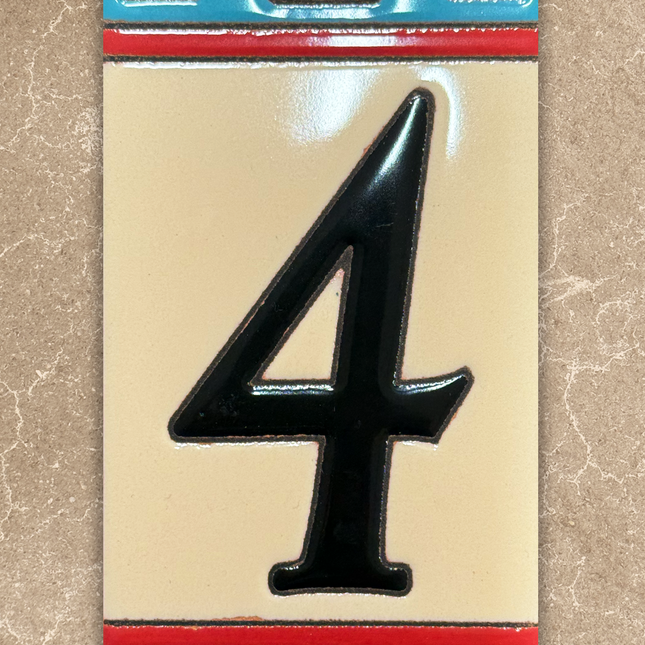Decorative number '4' tile with colorful border on a beige background