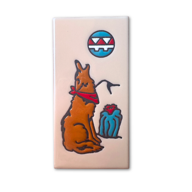 Rectangular tile with a cartoon coyote wearing a red bandana and a blue gift box on a beige background.
