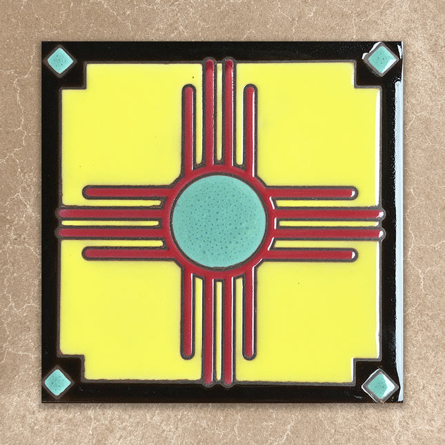 Decorative tile with a red and blue design on a yellow background, framed by black and turquoise accents.