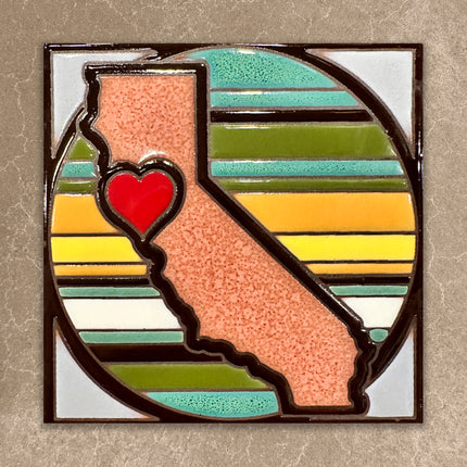 Tile with California shape and heart on a multicolored striped background