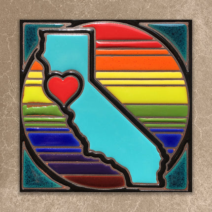 Colorful california tile with a heart in the center on a textured surface
