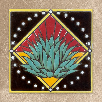 Decorative tile with a geometric design featuring a central green plant-like shape on a beige background.