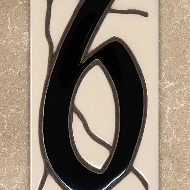 Decorative number '6' with black and blue design on a beige background