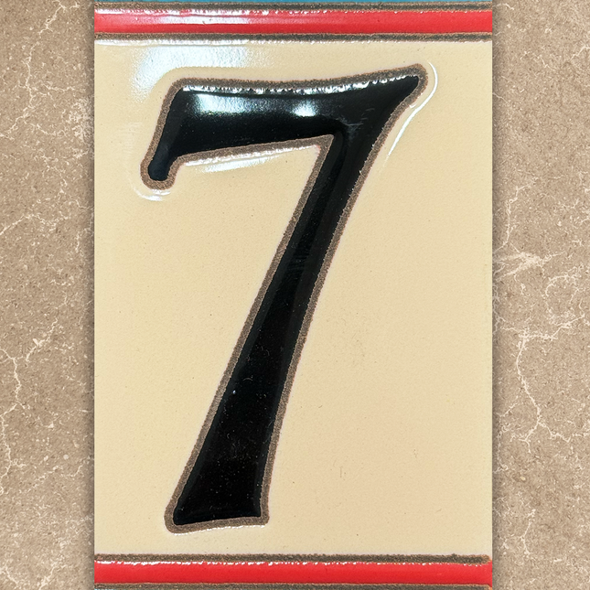 Black number '7' on a decorative card with colorful border on a beige background