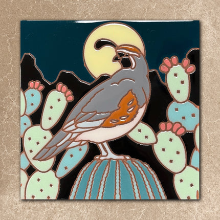 ceramic tile with a bird design on a cactus against a moonlit sky