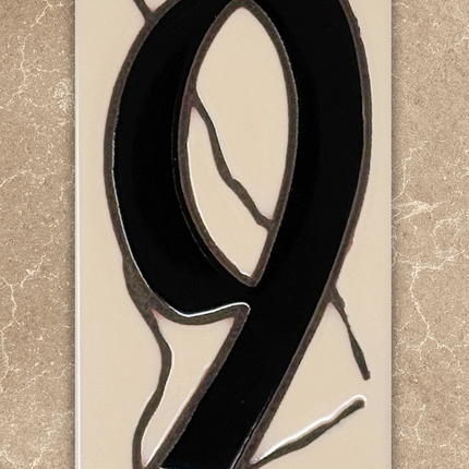 Stained glass number '9' on a beige background