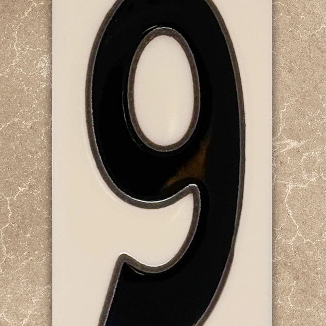 Black number '9' on a beige background
