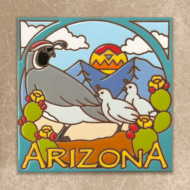Decorative tile with desert scene featuring a mountain, sunset, and desert animals on a beige background.