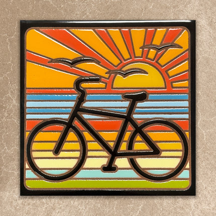 Bicycle design on a colorful sunburst background with a black border. ceramic tile wall art