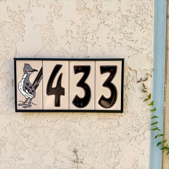black numbers on beige tile house sign
