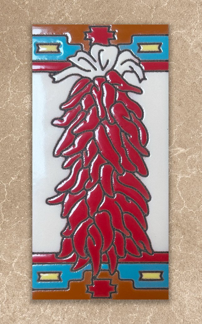 Decorative tile with red chili design on a beige background