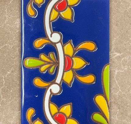 Decorative tile with floral patterns on a blue background