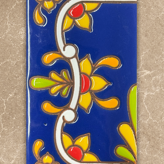 Decorative tile with floral patterns on a blue background