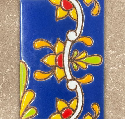 Decorative tile with colorful floral patterns on a blue background