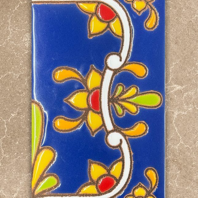 Decorative tile with colorful floral patterns on a blue background