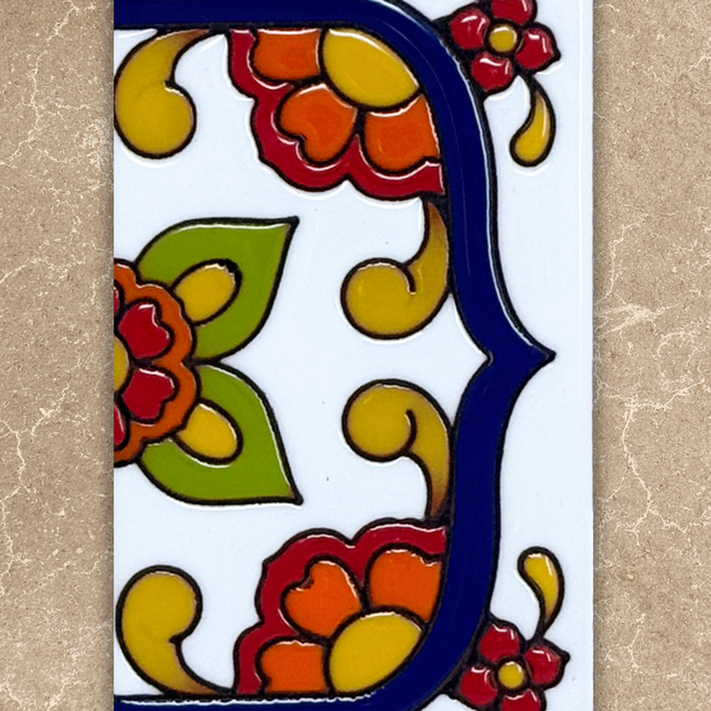 Decorative tile with colorful floral design on a beige background