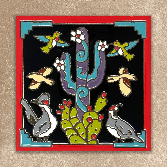 ceramic tile with cactus, birds, and other desert animals on a black background with a red border.