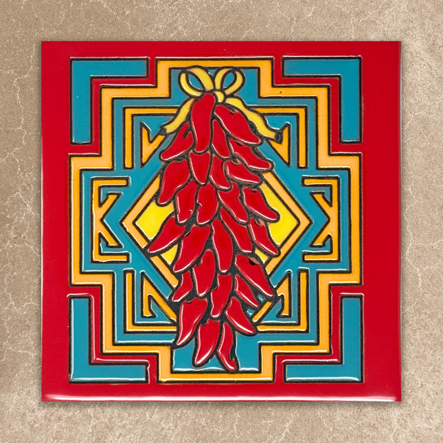 Decorative tile with red chili peppers and geometric pattern on a beige background
