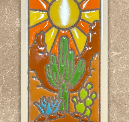 Decorative tile with a cactus and sun design on a beige background
