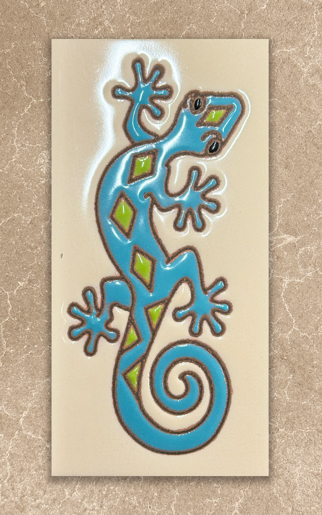 Decorative tile with a blue and green lizard design on a beige background