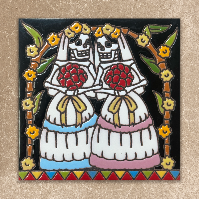 Decorative tile with two skeletons holding flowers, framed by floral elements on a beige background
