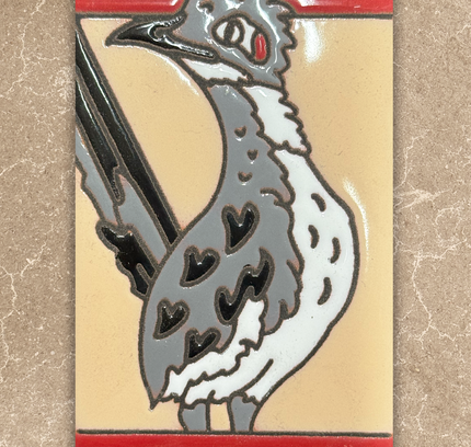 Decorative tile with a rooster design on a beige background